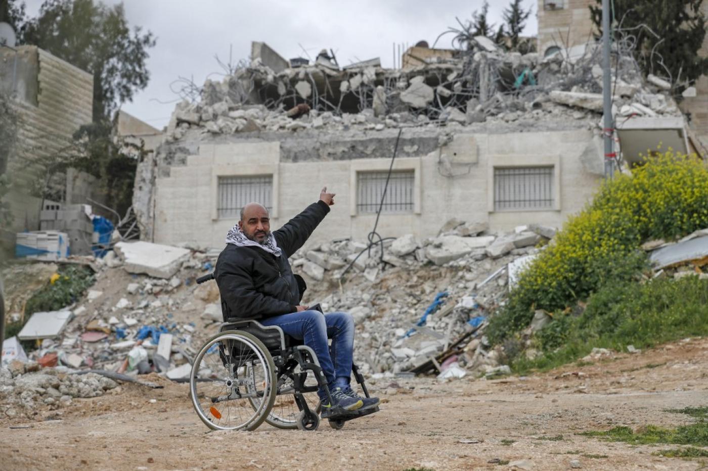 Palestinian Hatem Hussein Abu Rayala points at his house which was demolished again by Israeli forces in the East Jerusalem neighbourhood of Issawiya, 1 March 2021 (AFP)